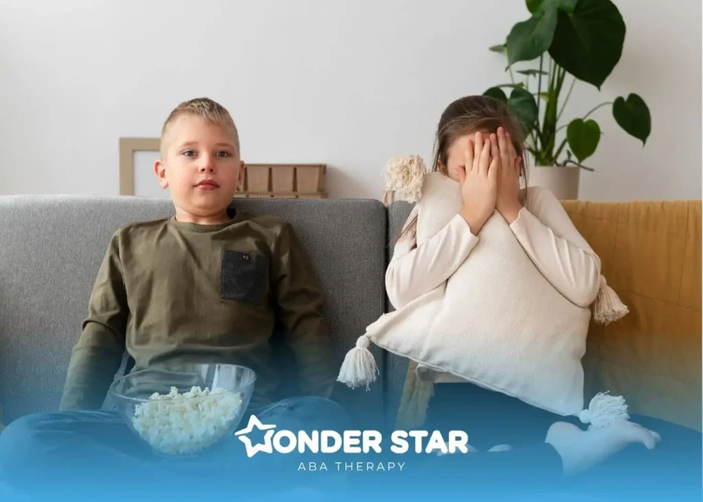 An autistic girl covering face with a pillow while sitting beside another autistic, showing emotional overwhelm.