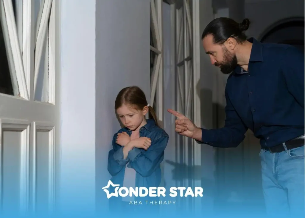 Adult pointing while scolding a sad autistic girl standing in hallway, showing emotional distress and discipline in a home.