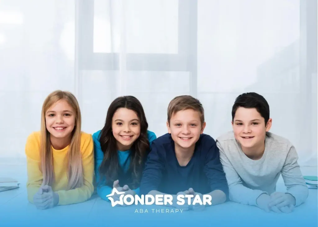 A group of smiling autistic kids lying on the floor together, representing diversity and social connection in childhood.
