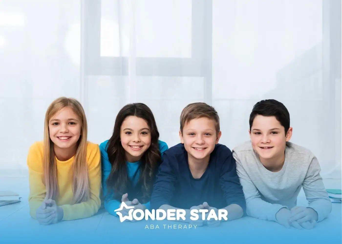 A group of smiling autistic kids lying on the floor together, representing diversity and social connection in childhood.
