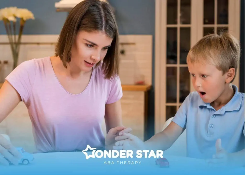 Therapist and a young autistic boy playing with toy cars at a table, the child reacting with surprise and excitement.