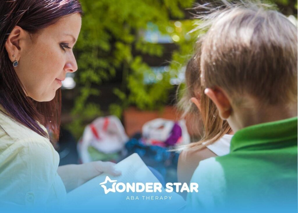 Therapist reading a book aloud to two autistic children outdoors while sitting together and focusing on the pages.